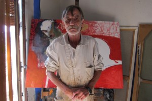 Artist Robert Anglada in his studio in front of unfinished oil